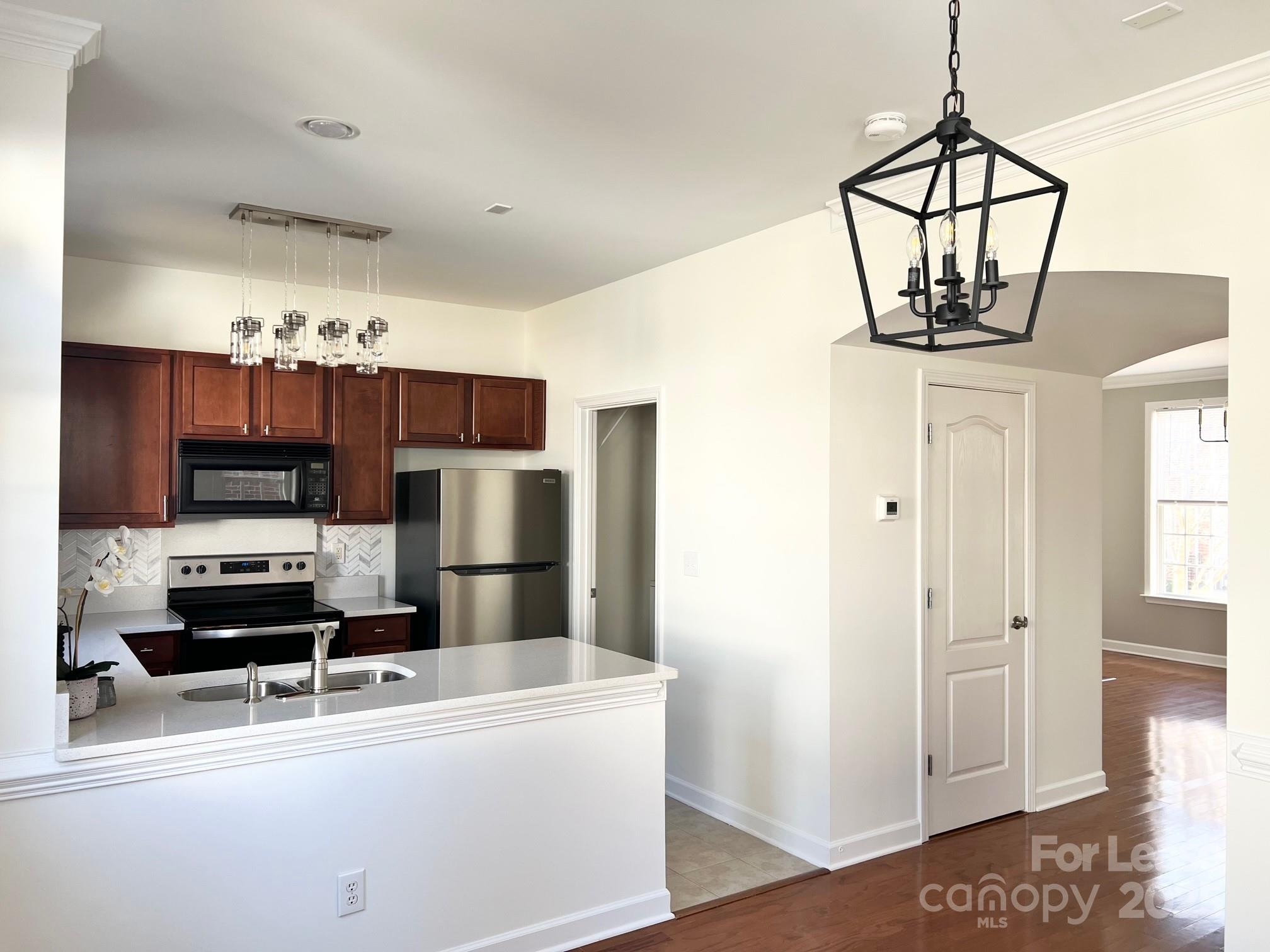630 Old Meeting Way Davidson, NC 28036 - Photo 8 of 19 a kitchen with stainless steel appliances a refrigerator a stove a sink and a microwave
