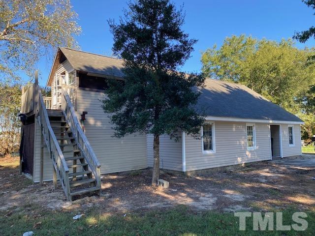 2268 Sanders Road Willow Spring, NC 27592 - Photo 1 of 11 a backyard of a house with lots of green space
