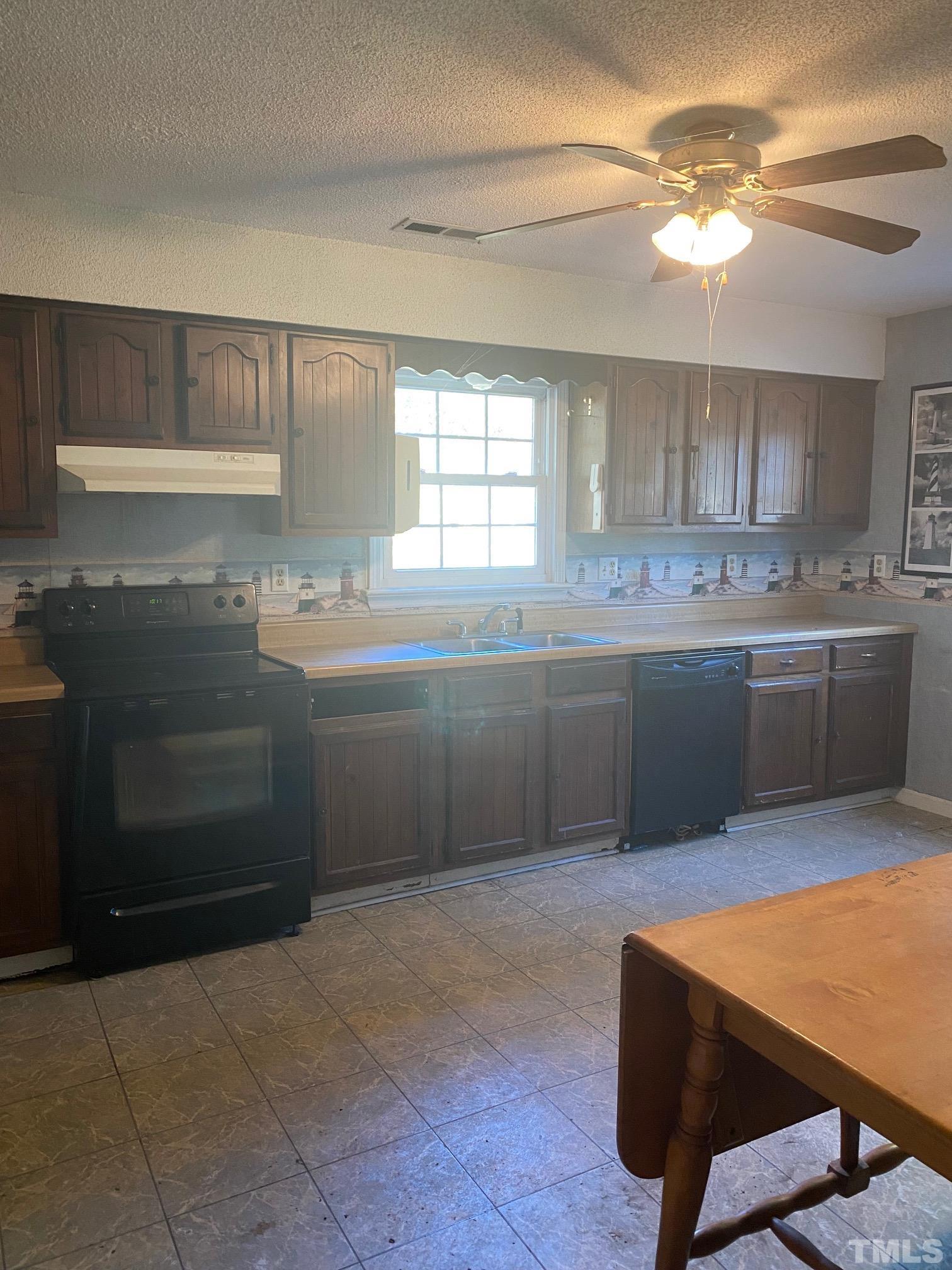 2268 Sanders Road Willow Spring, NC 27592 - Photo 5 of 11 a kitchen with stainless steel appliances granite countertop a sink and cabinets