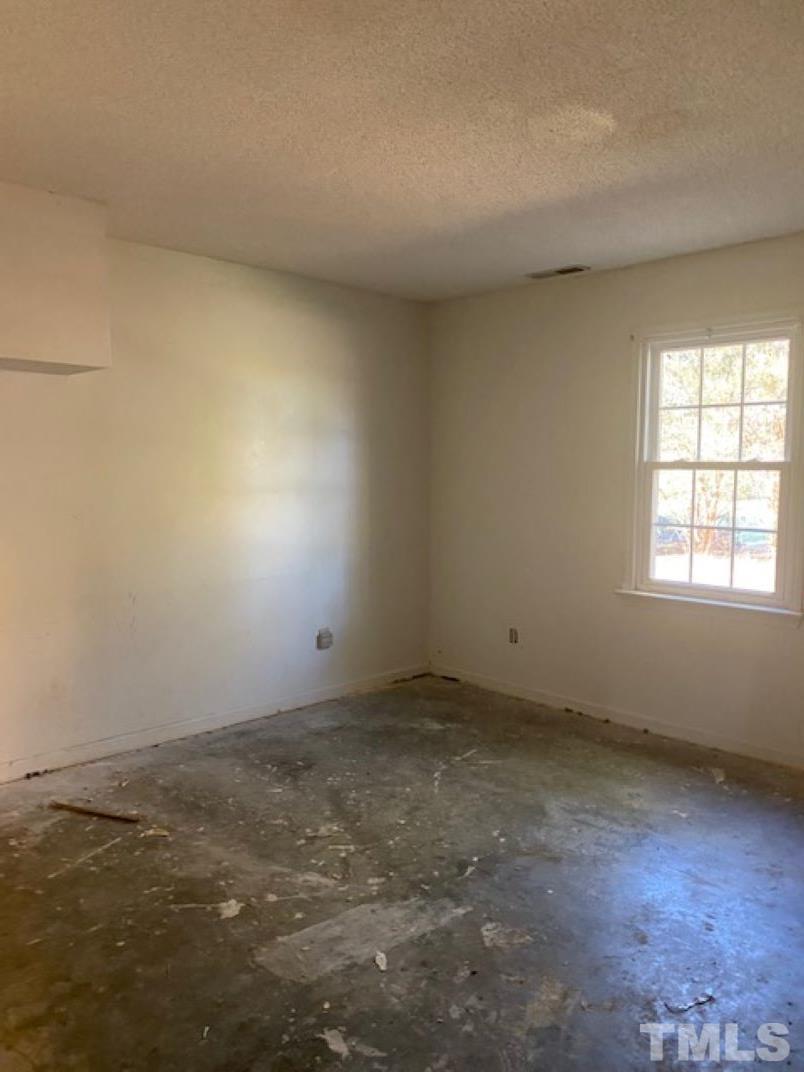 2268 Sanders Road Willow Spring, NC 27592 - Photo 6 of 11 an empty room with a window