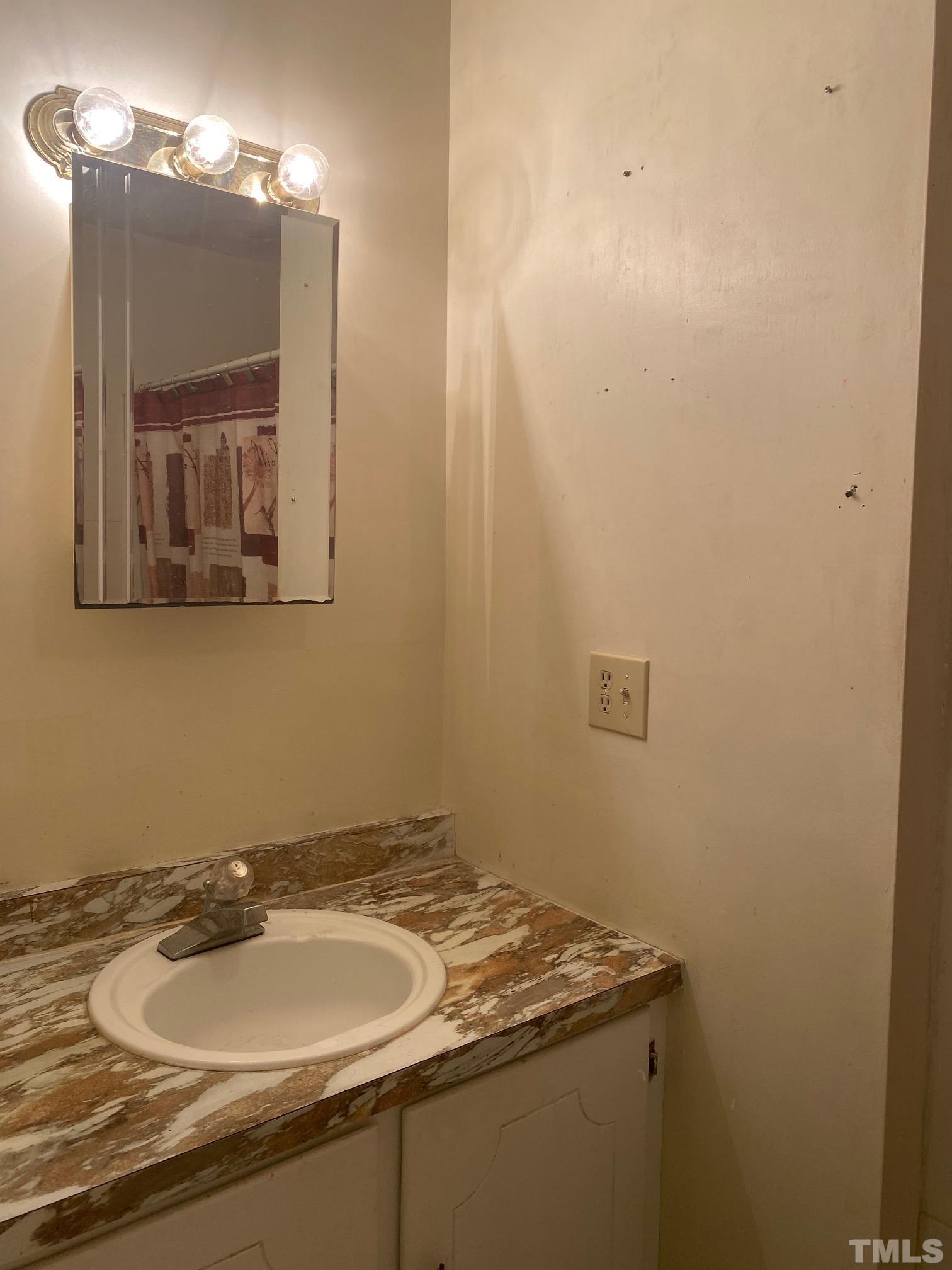 2268 Sanders Road Willow Spring, NC 27592 - Photo 8 of 11 a bathroom with a granite countertop sink and a mirror