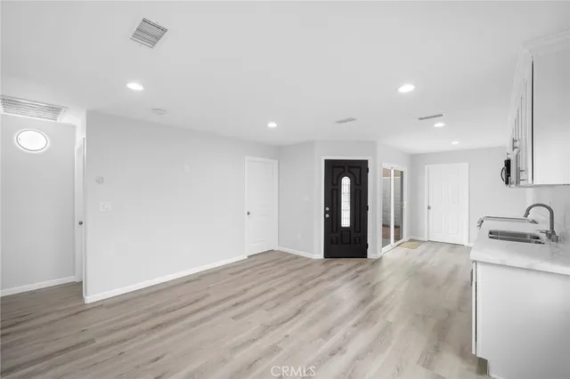 a view of a kitchen with a sink and a refrigerator