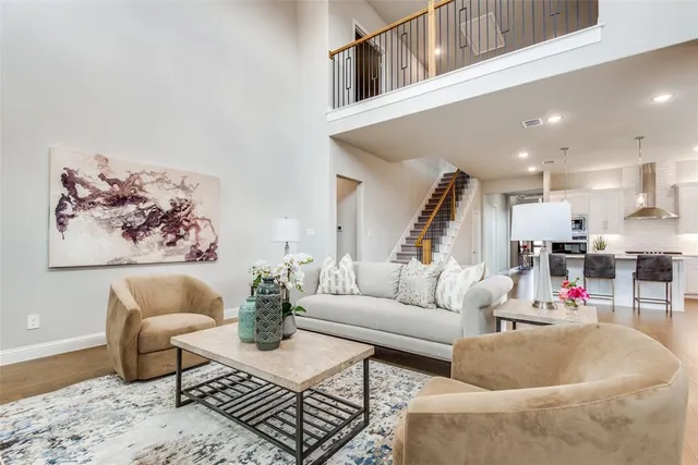a living room with furniture and kitchen view