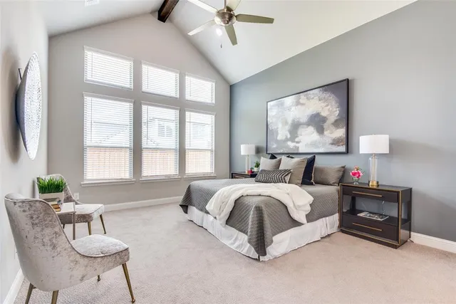 a spacious bedroom with a bed a couch and a window