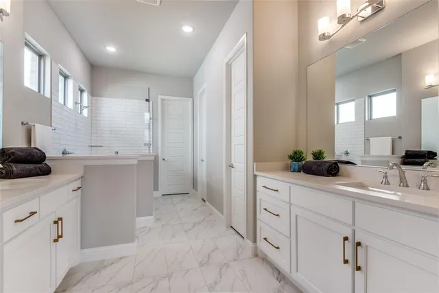 a kitchen with white cabinets and sink