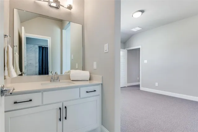 a bathroom with a sink vanity and mirror