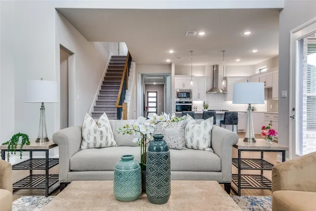 a living room with furniture and a potted plant