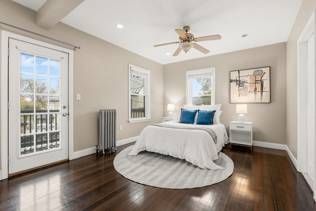 77 Wheatland Street, Unit 2 Somerville, MA 02145 - Photo 12 of 20 a spacious bedroom with a bed and wooden floor