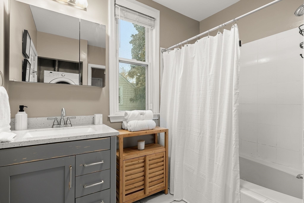 77 Wheatland Street, Unit 2 Somerville, MA 02145 - Photo 15 of 20 a en suite bathroom with a sink a vanity and a mirror