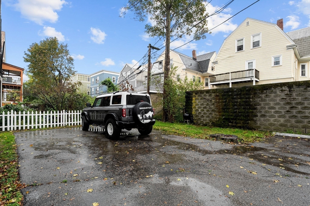 77 Wheatland Street, Unit 2 Somerville, MA 02145 - Photo 20 of 20 a view of a house with a yard and deck