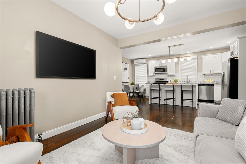77 Wheatland Street, Unit 2 Somerville, MA 02145 - Photo 2 of 20 a living room with furniture and a flat screen tv