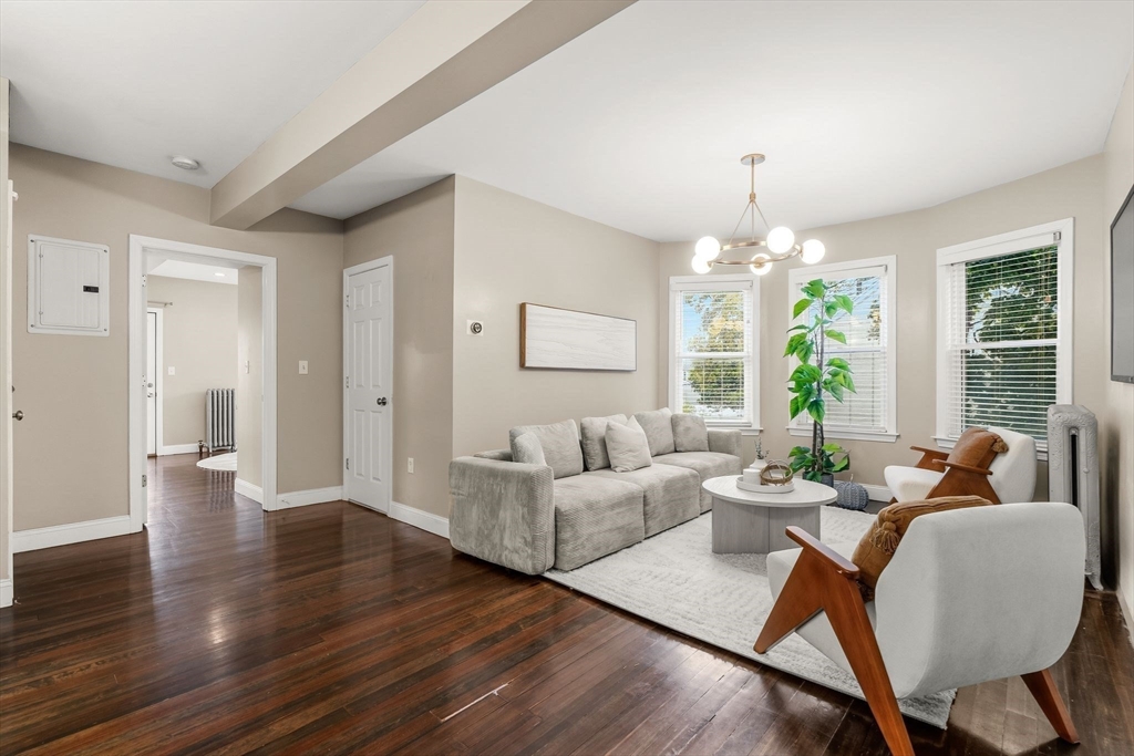 77 Wheatland Street, Unit 2 Somerville, MA 02145 - Photo 10 of 20 a living room with furniture and a chandelier