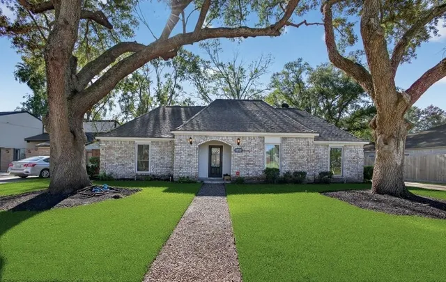 a front view of house with yard and green space