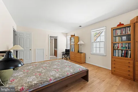 a bed room with a bed and a book shelf