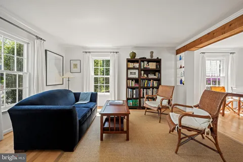 a living room with furniture and a book shelf