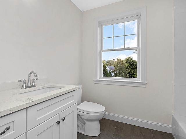 1 Pleasant Street, Unit 201 Cohasset, MA 02025 - Photo 4 of 20 a bathroom with a toilet a sink a vanity and window
