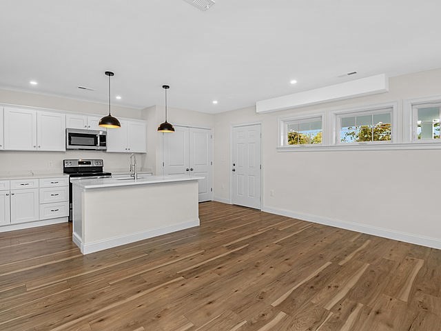 1 Pleasant Street, Unit 201 Cohasset, MA 02025 - Photo 8 of 20 a view of kitchen with wooden floor stainless steel appliances and cabinets