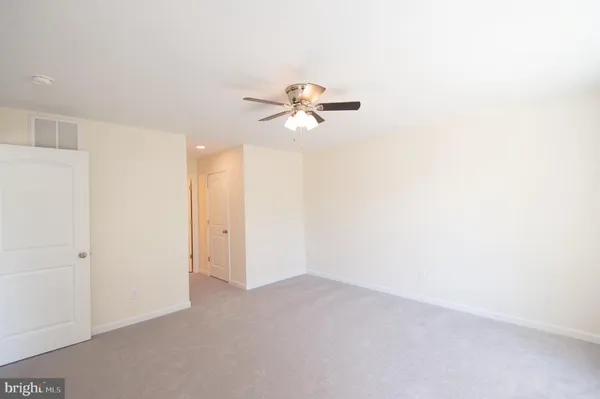 a view of a room with a ceiling fan and a chandelier fan