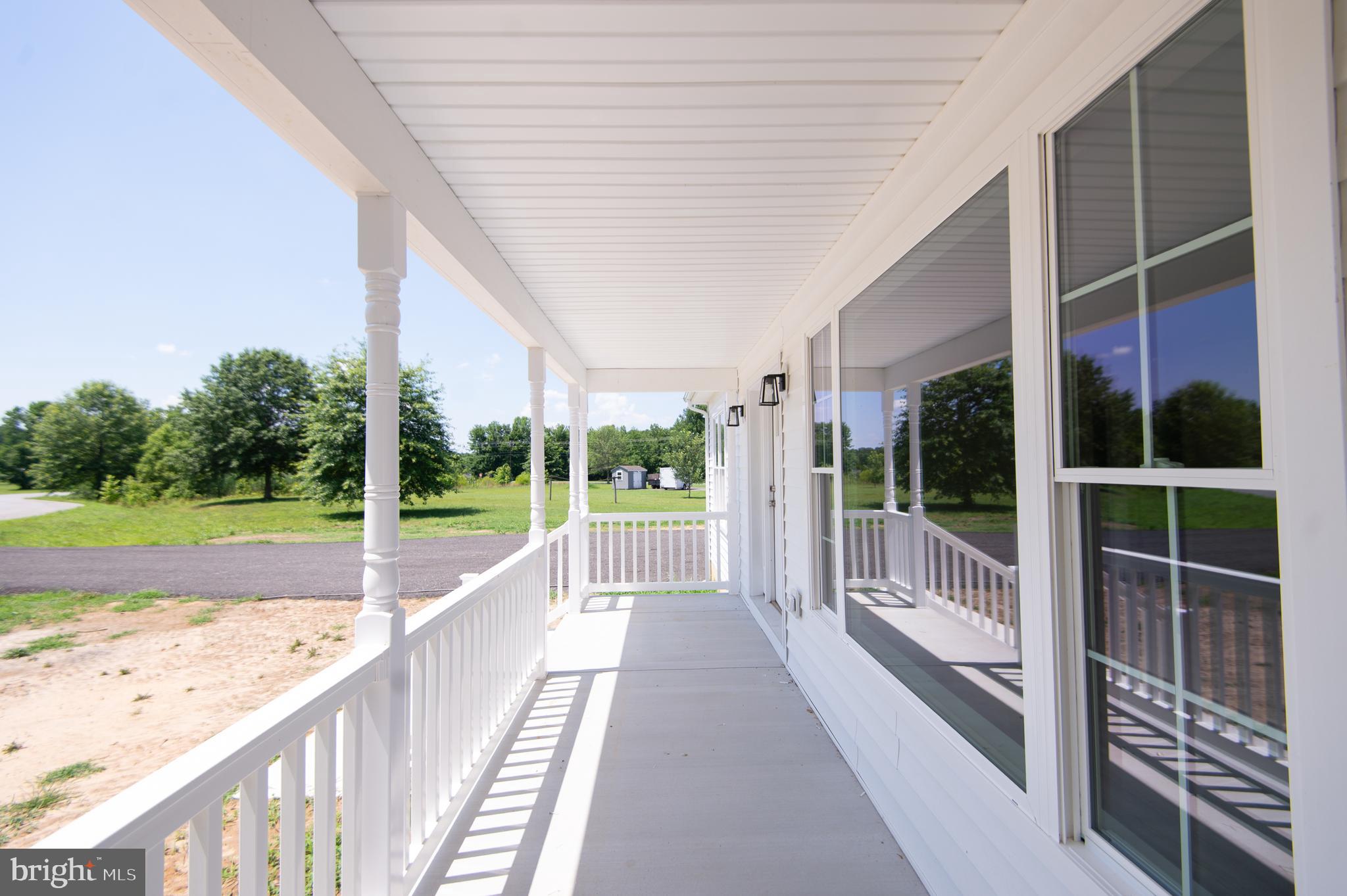 6706 Jayar Way Hurlock, MD 21643 - Photo 15 of 19 a view of swimming pool with balcony and floor to ceiling window next to a yard