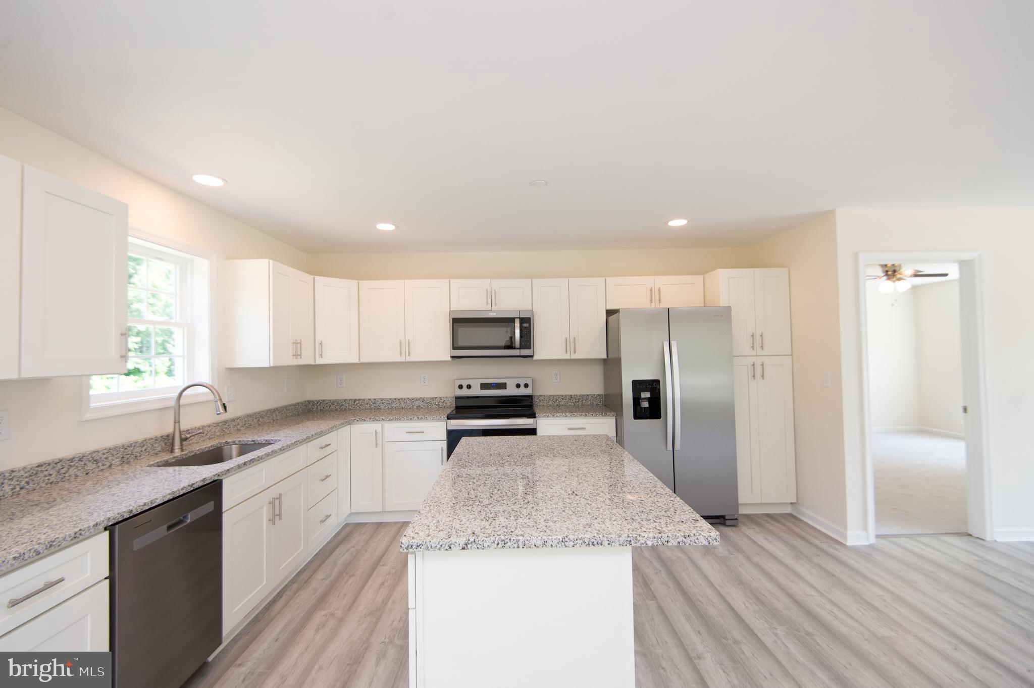 6706 Jayar Way Hurlock, MD 21643 - Photo 5 of 19 a kitchen with a sink stove and refrigerator