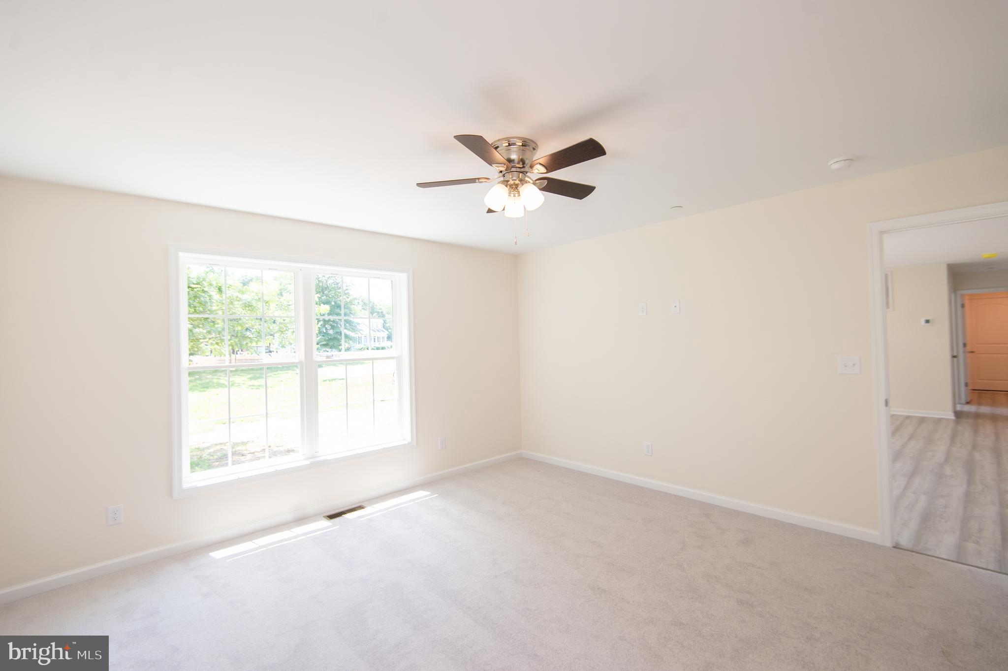 6706 Jayar Way Hurlock, MD 21643 - Photo 7 of 19 an empty room with a window and a ceiling fan