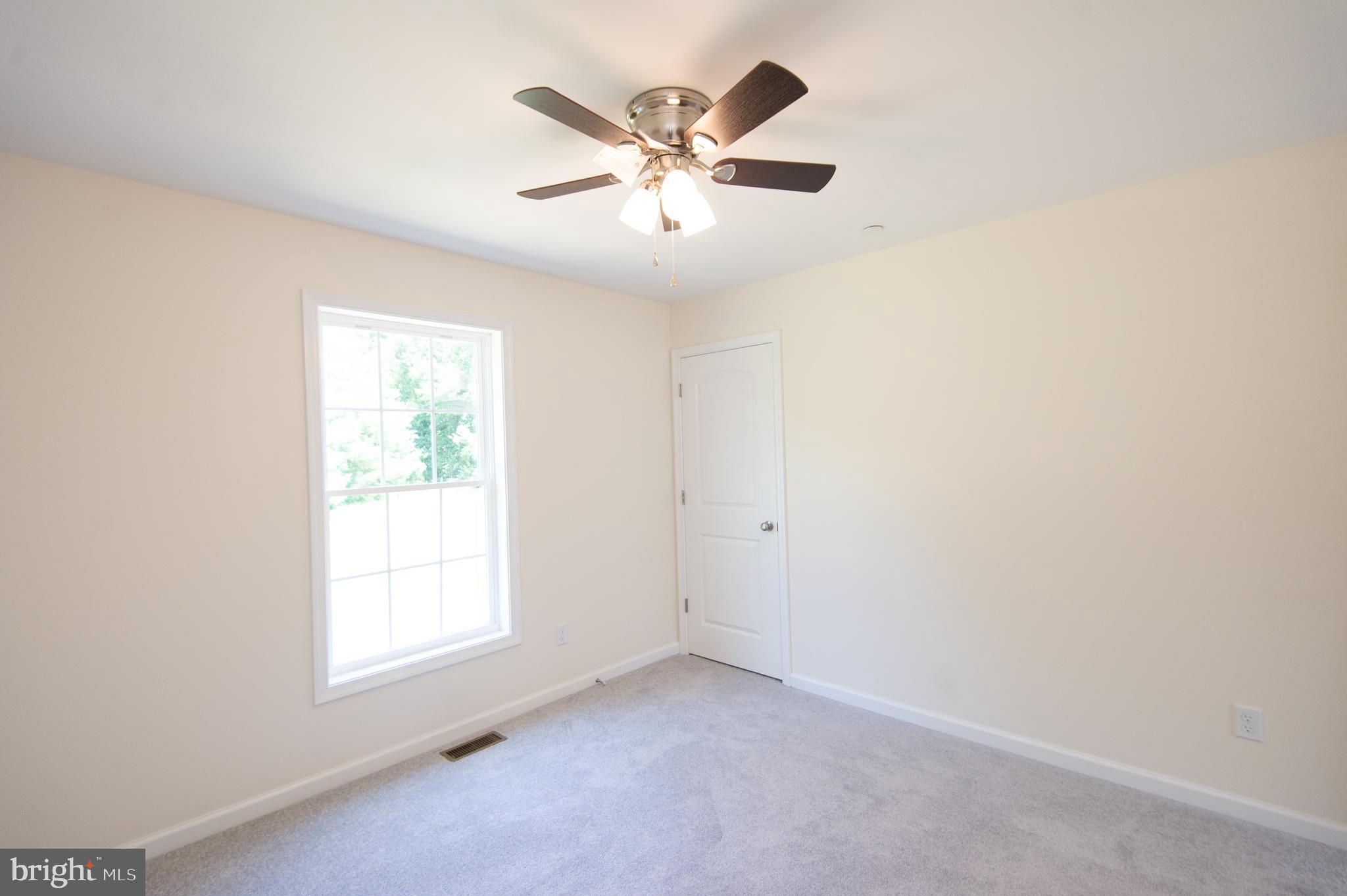6706 Jayar Way Hurlock, MD 21643 - Photo 9 of 19 an empty room with windows and fan