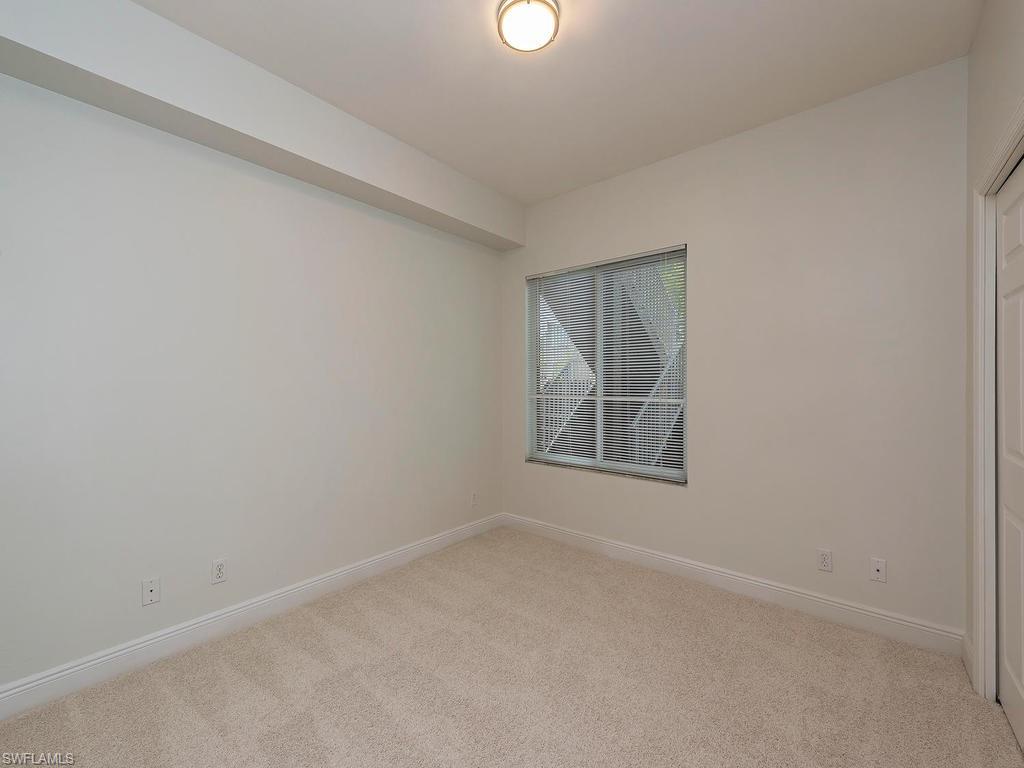 5470 16th Place Southwest, Unit 103 Naples, FL 34116 - Photo 11 of 12 an empty room with a window