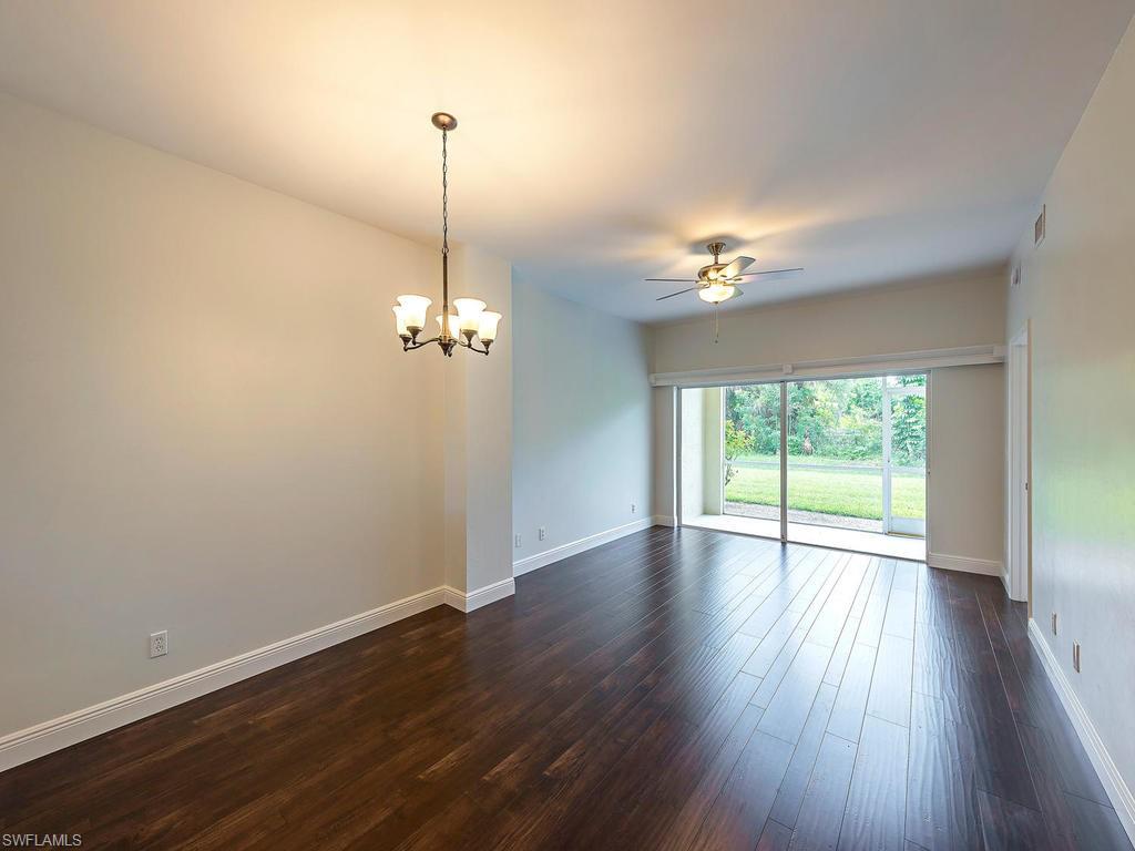 5470 16th Place Southwest, Unit 103 Naples, FL 34116 - Photo 2 of 12 a view of a room with wooden floor fan and window