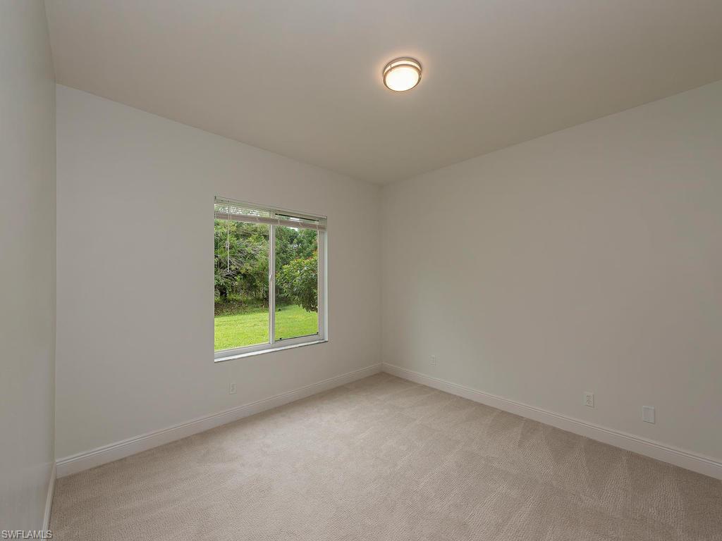 5470 16th Place Southwest, Unit 103 Naples, FL 34116 - Photo 6 of 12 an empty room with a window