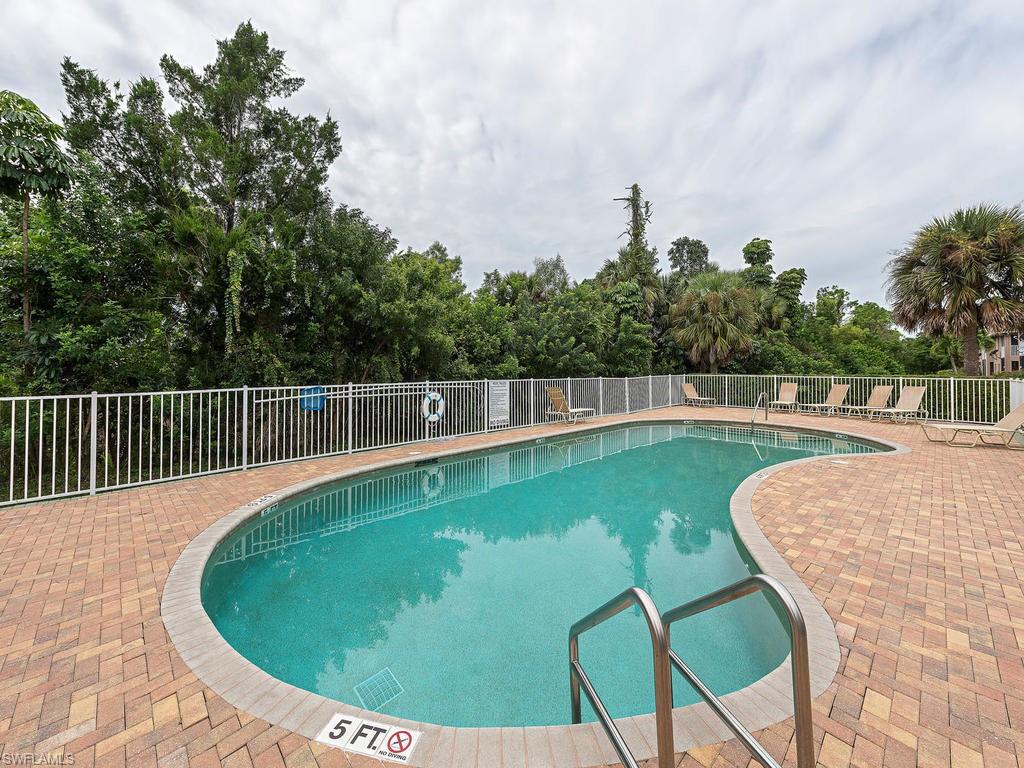 5470 16th Place Southwest, Unit 103 Naples, FL 34116 - Photo 8 of 12 a view of a swimming pool with a outdoor seating