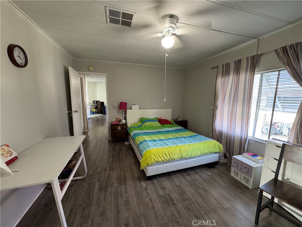 9800 Base Line Road, Unit 76 Rancho Cucamonga, CA 91701 - Photo 11 of 20 a bedroom with a bed and a chandelier