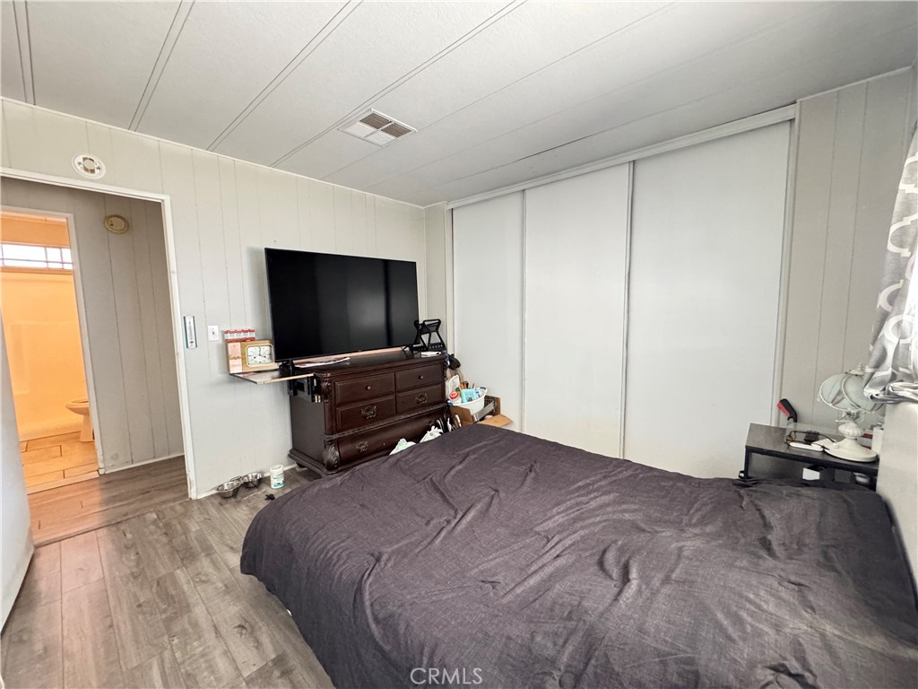 9800 Base Line Road, Unit 76 Rancho Cucamonga, CA 91701 - Photo 12 of 20 a bedroom with a bed and a flat screen tv
