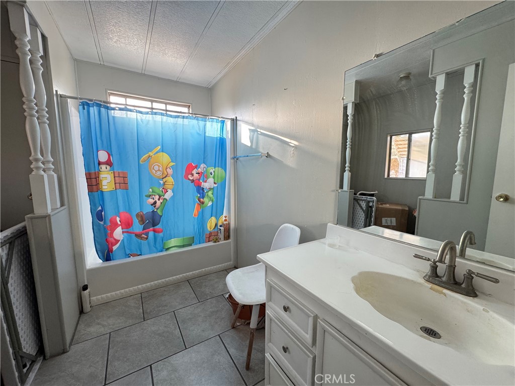 9800 Base Line Road, Unit 76 Rancho Cucamonga, CA 91701 - Photo 13 of 20 a bathroom with a sink mirror and vanity