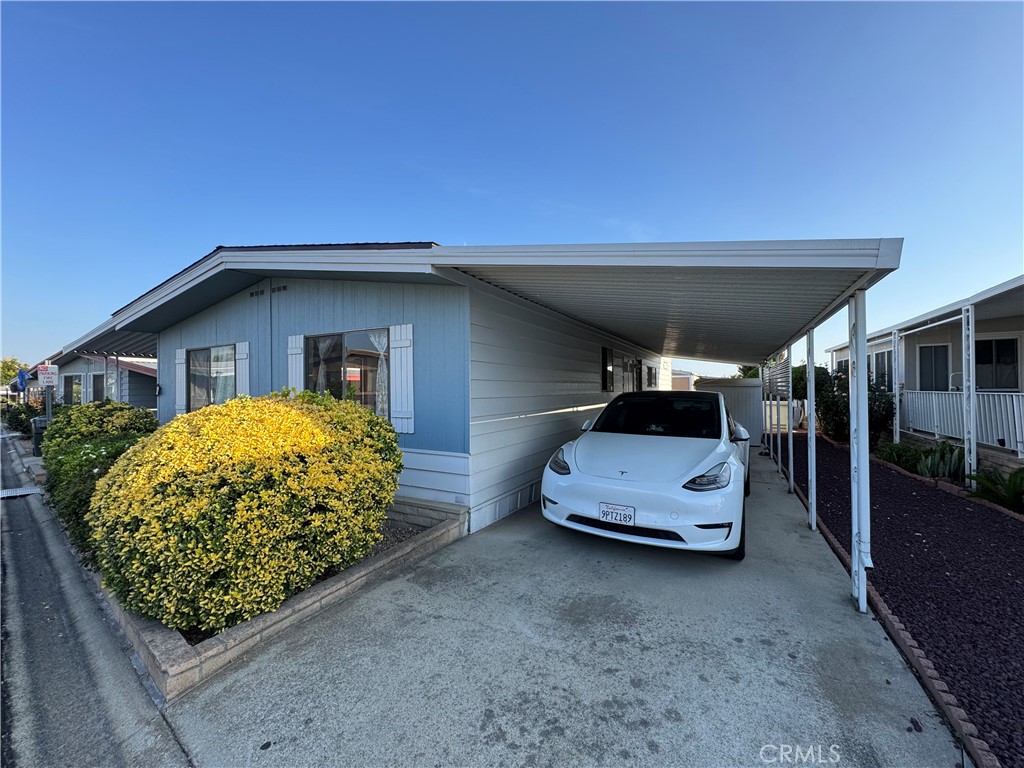 9800 Base Line Road, Unit 76 Rancho Cucamonga, CA 91701 - Photo 15 of 20 a front view of a house with a garden