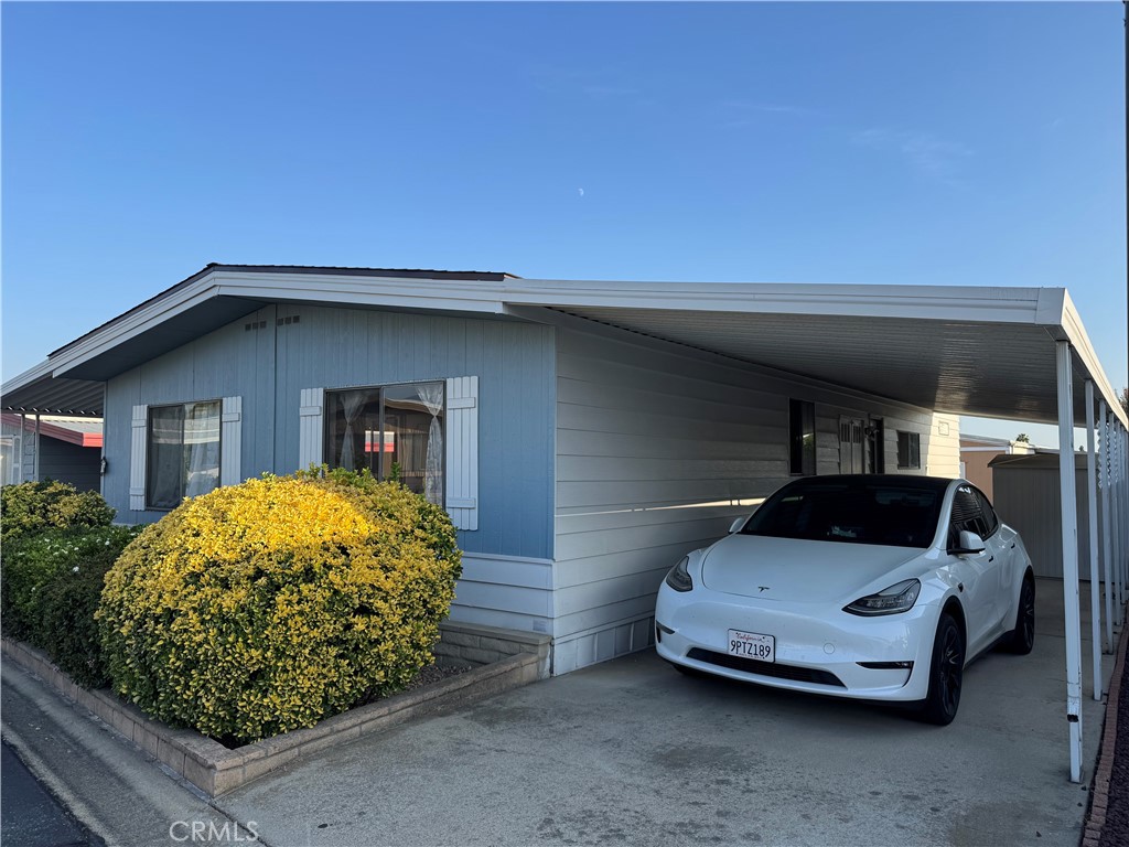 9800 Base Line Road, Unit 76 Rancho Cucamonga, CA 91701 - Photo 16 of 20 a car parked in front of a house