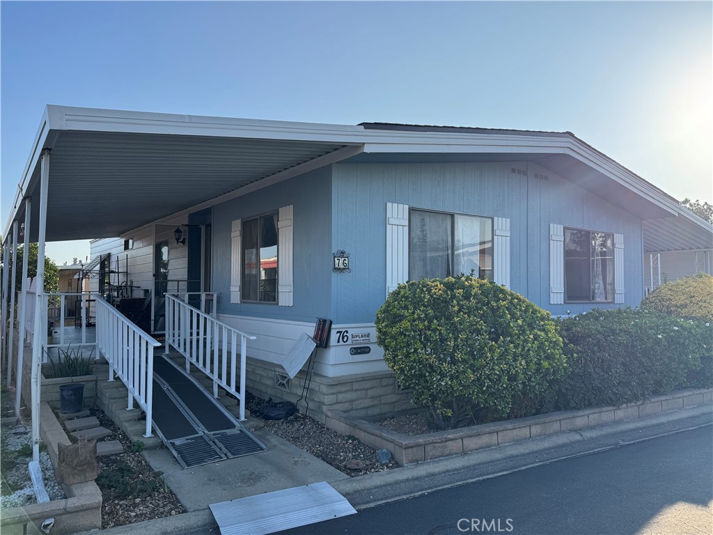 9800 Base Line Road, Unit 76 Rancho Cucamonga, CA 91701 - Photo 3 of 20 a view of a house with a small yard and wooden floor and fence