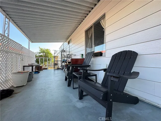 a building outdoor space with patio furniture and potted plants