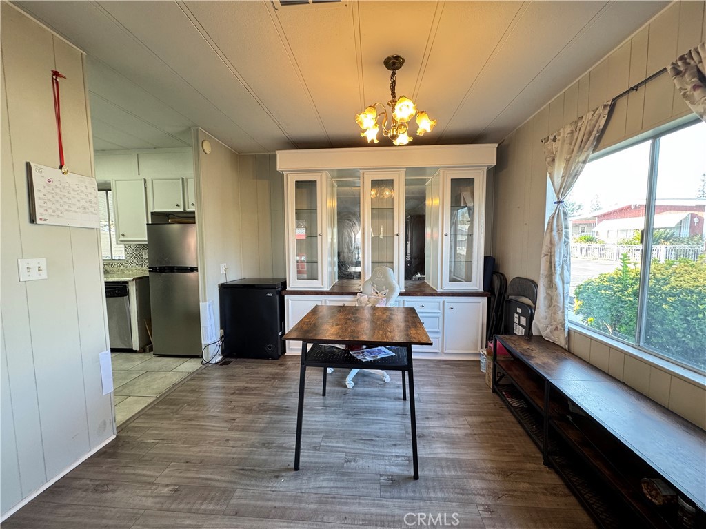 9800 Base Line Road, Unit 76 Rancho Cucamonga, CA 91701 - Photo 9 of 20 a view of a dining room with furniture a chandelier and wooden floor
