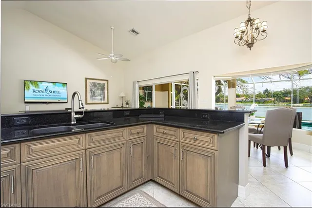 a kitchen with a sink and view of living room