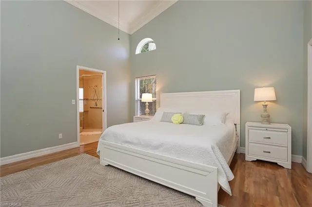 a bedroom with a bed and a night stand