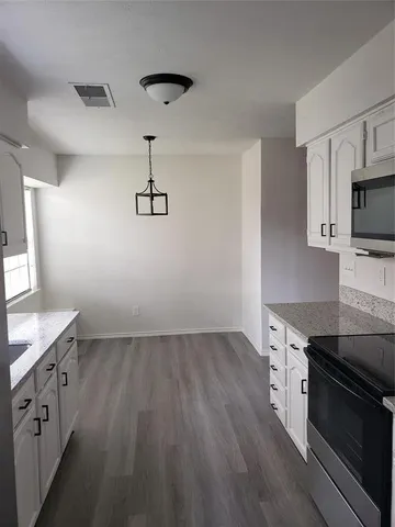 a kitchen with stainless steel appliances a sink dishwasher stove microwave and cabinets