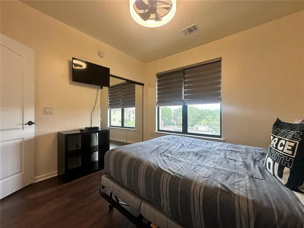 a bathroom with a double vanity sink a large mirror and a bathtub