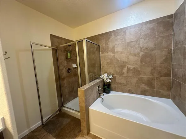 a bathroom with a double vanity sink toilet and shower