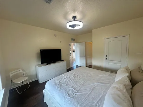 a bedroom with a bed and window