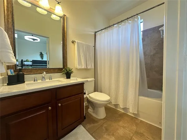 a bathroom with a tub double sink and mirror