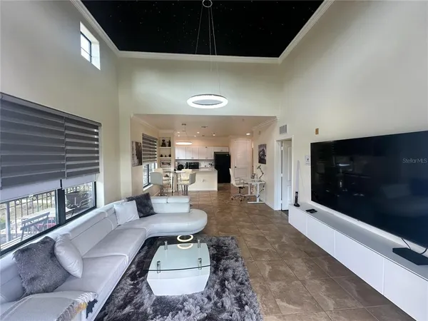 a kitchen with a sink a refrigerator and cabinets