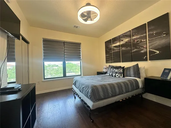 a living room with furniture a chandelier and a large window
