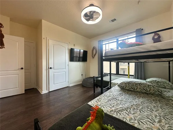 a bedroom with a bed and wooden floor