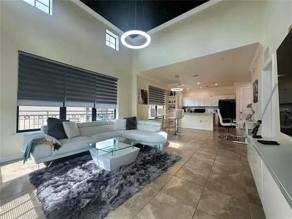 a spacious bedroom with a bed and a large window