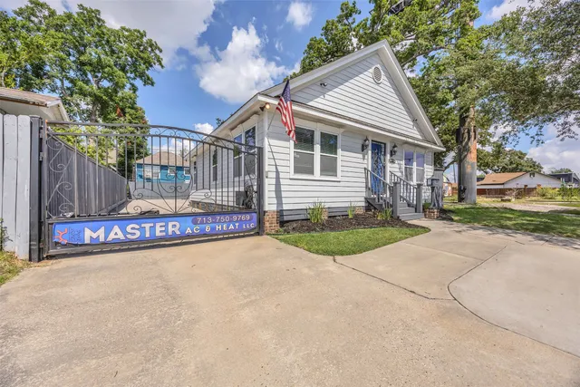 a view of a house with a yard and tree s